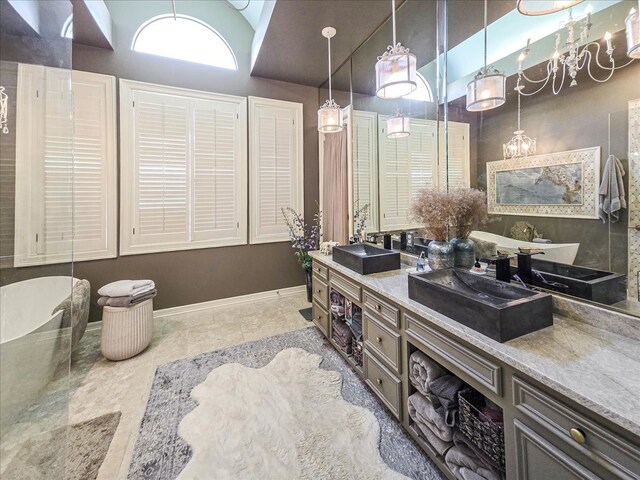 bathroom featuring vanity, lofted ceiling, and a tub