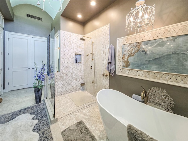 bathroom featuring independent shower and bath, tile patterned flooring, and a chandelier