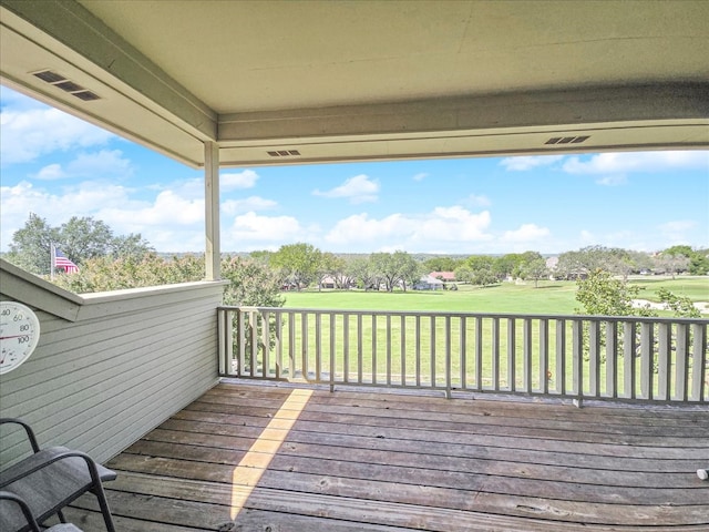 wooden deck featuring a yard