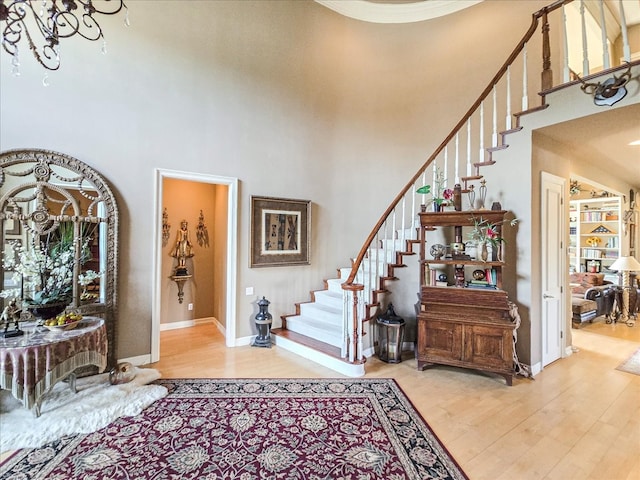 entrance foyer with a high ceiling and light hardwood / wood-style floors