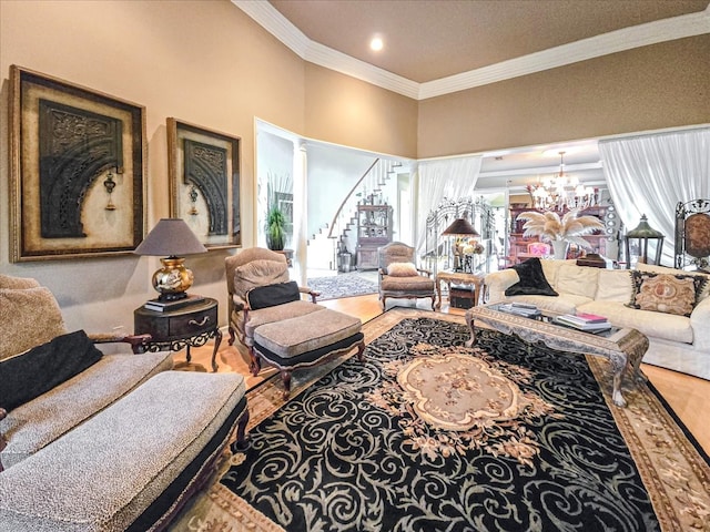 living room with wood-type flooring, crown molding, an inviting chandelier, and a wealth of natural light