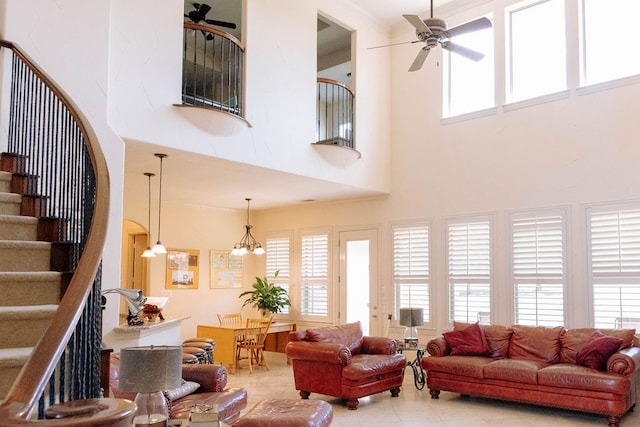 tiled living room with a towering ceiling and ceiling fan