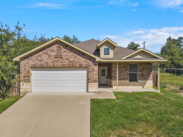 view of front of house featuring a front yard and a garage