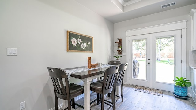 dining space featuring french doors and hardwood / wood-style flooring