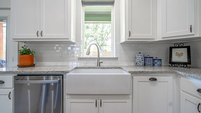 kitchen with sink, backsplash, white cabinetry, dishwasher, and light stone countertops