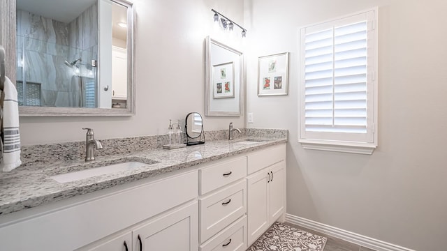 bathroom with a shower, vanity, and hardwood / wood-style flooring