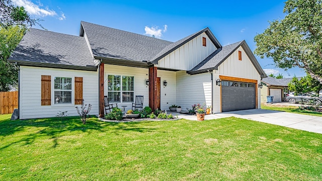 view of front of house featuring a garage and a front lawn