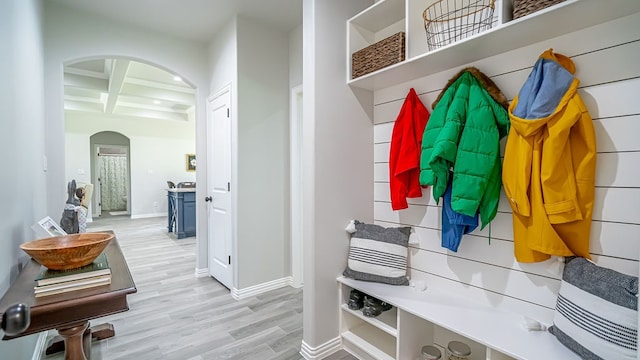 mudroom featuring coffered ceiling, beamed ceiling, and light wood-type flooring