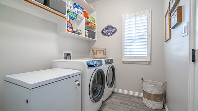 laundry room featuring hardwood / wood-style floors and washer and dryer