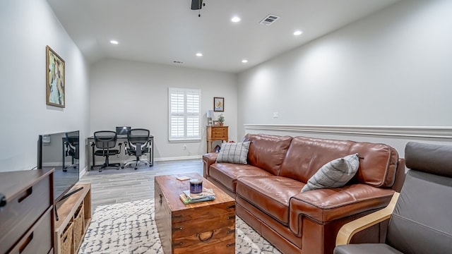 living room featuring light wood-type flooring and lofted ceiling