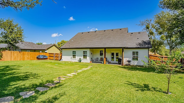 rear view of house with a yard