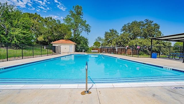 view of pool with an outbuilding