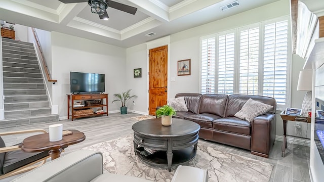 living room featuring beamed ceiling, ceiling fan, coffered ceiling, and a healthy amount of sunlight