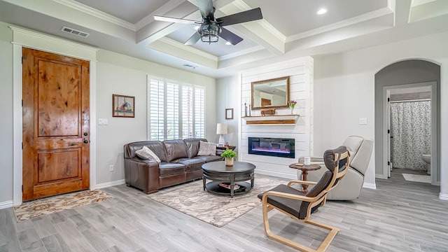 living room featuring light hardwood / wood-style flooring, ceiling fan, coffered ceiling, and a fireplace