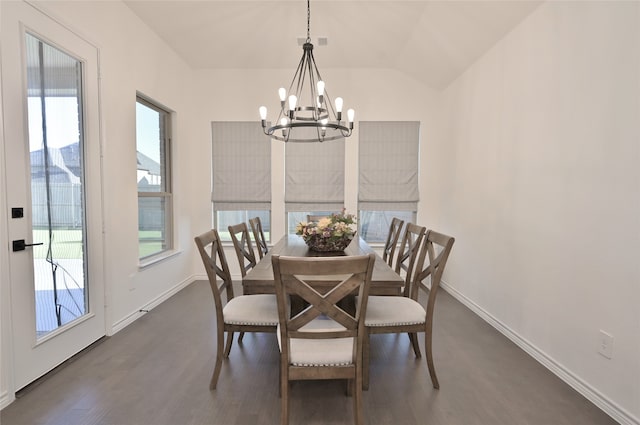 dining room with a notable chandelier, vaulted ceiling, a healthy amount of sunlight, and dark hardwood / wood-style flooring