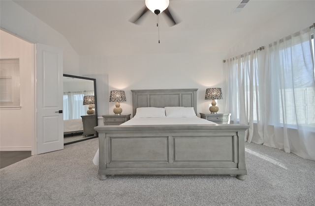 carpeted bedroom featuring multiple windows, lofted ceiling, and ceiling fan