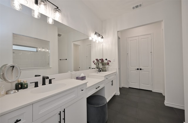 bathroom featuring tile patterned flooring and vanity