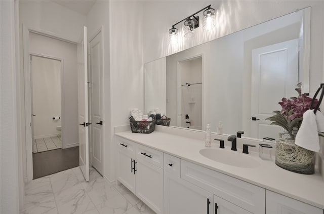 bathroom featuring vanity and toilet