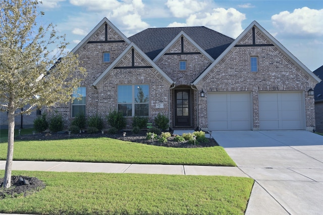 view of front of home featuring a front lawn and a garage