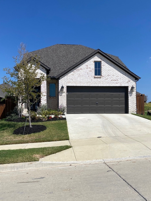 view of front of property with a garage and a front yard