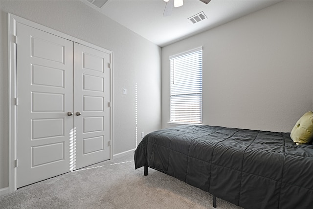 bedroom featuring carpet flooring, ceiling fan, and a closet