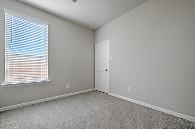 carpeted spare room with plenty of natural light