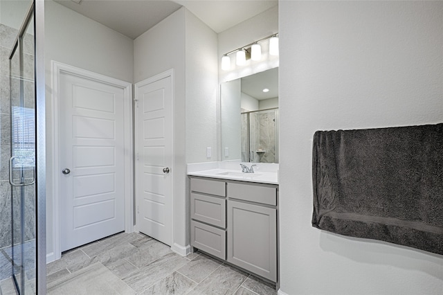 bathroom featuring vanity and a shower with door