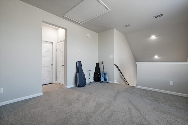 carpeted spare room with lofted ceiling