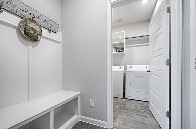 washroom with independent washer and dryer and hardwood / wood-style flooring