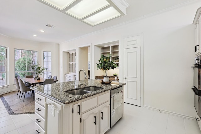 kitchen featuring white cabinets, dishwasher, ornamental molding, a kitchen island with sink, and sink