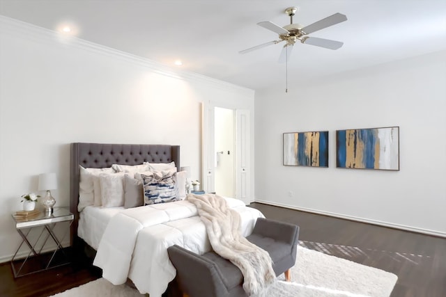 bedroom featuring crown molding, dark wood-type flooring, and ceiling fan