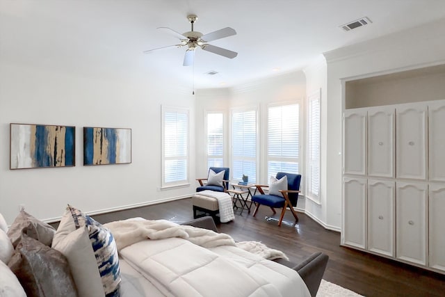 living room with ceiling fan, ornamental molding, and dark wood-type flooring