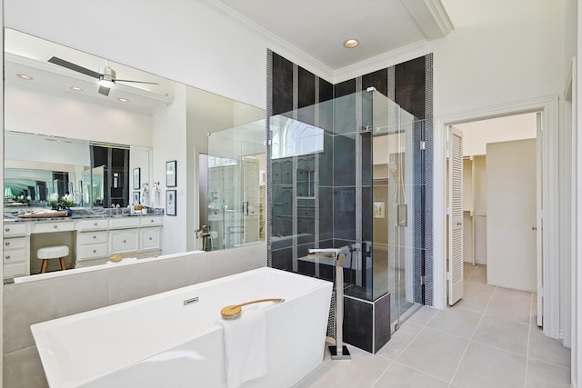 bathroom with plus walk in shower, tile patterned floors, ornamental molding, ceiling fan, and vanity