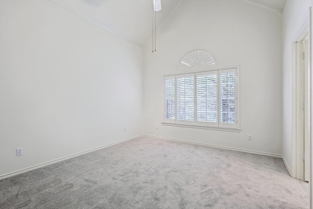 unfurnished room with carpet flooring and high vaulted ceiling