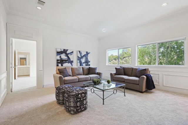 living room with light carpet and ornamental molding