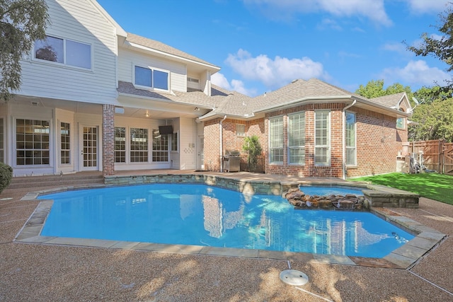 view of swimming pool with an in ground hot tub, area for grilling, and a patio area