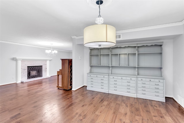 interior space featuring a notable chandelier, dark hardwood / wood-style floors, and crown molding