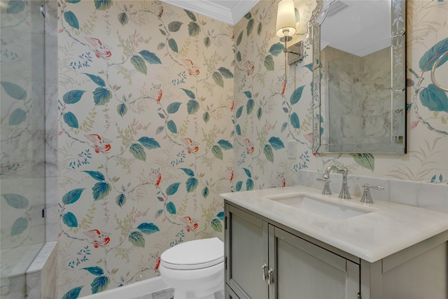 bathroom with ornamental molding, tiled shower, vanity, and toilet