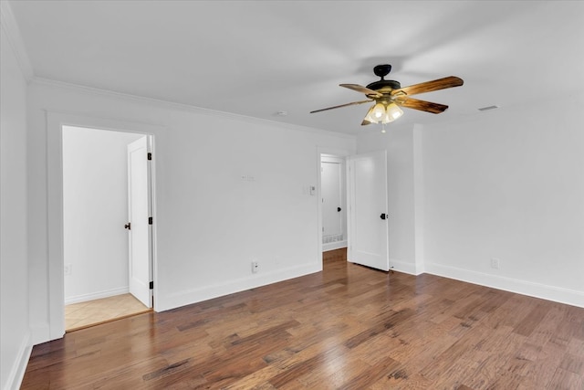 spare room with ornamental molding, ceiling fan, and hardwood / wood-style flooring