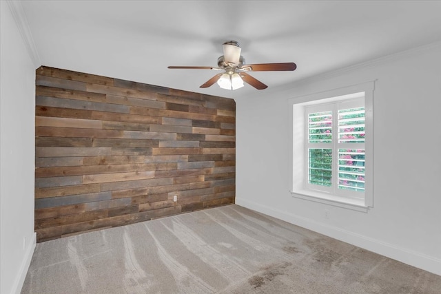 carpeted spare room with ornamental molding and ceiling fan