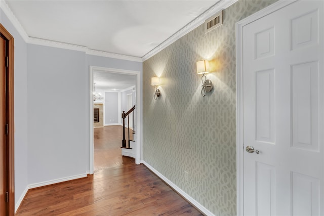 hall featuring ornamental molding and hardwood / wood-style flooring