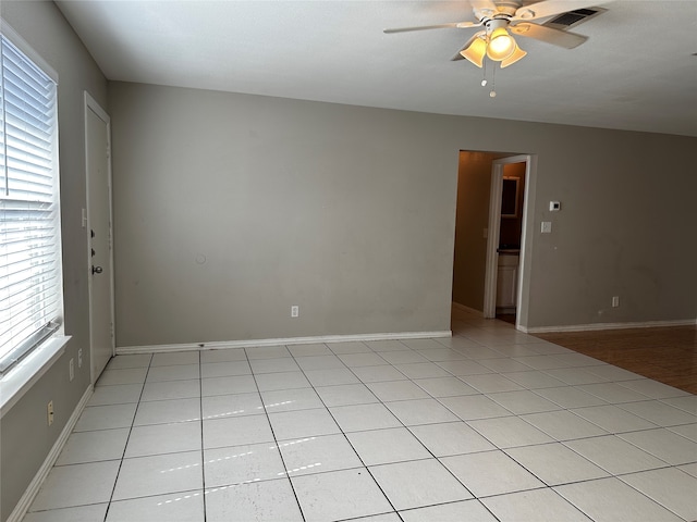 empty room featuring ceiling fan and light tile patterned floors