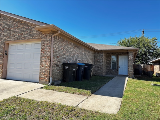 view of front of house featuring a garage and a front lawn