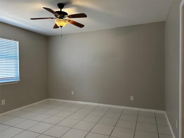 spare room featuring light tile patterned floors and ceiling fan