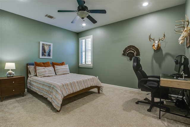 bedroom with ceiling fan and light colored carpet