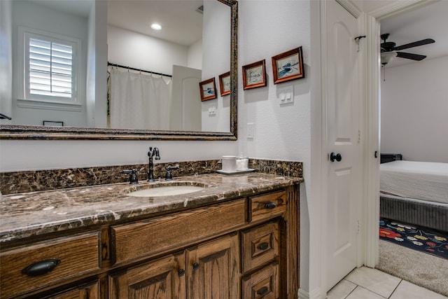 bathroom with tile patterned flooring, vanity, and ceiling fan