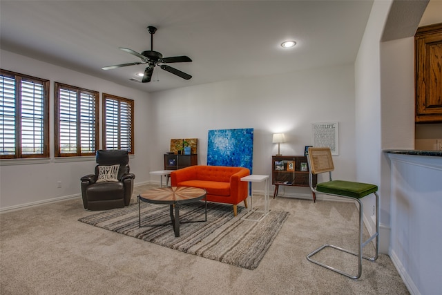 interior space with ceiling fan and light colored carpet