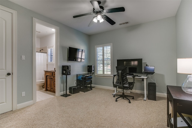 office space featuring ceiling fan and light colored carpet