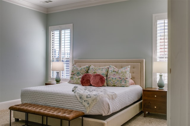 bedroom with carpet floors and crown molding