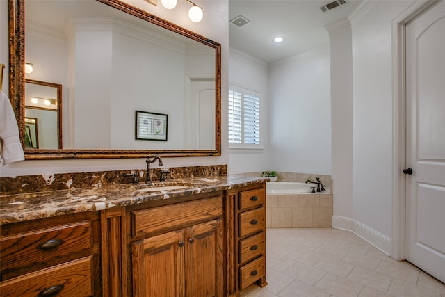 bathroom featuring tiled bath, vanity, and crown molding